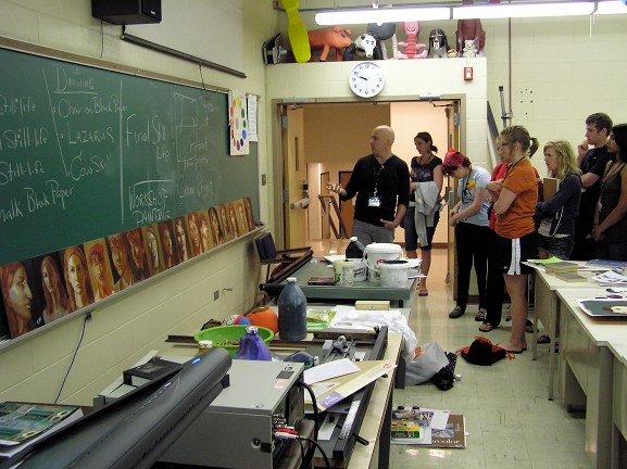 John Wellington discusses the portraits with students