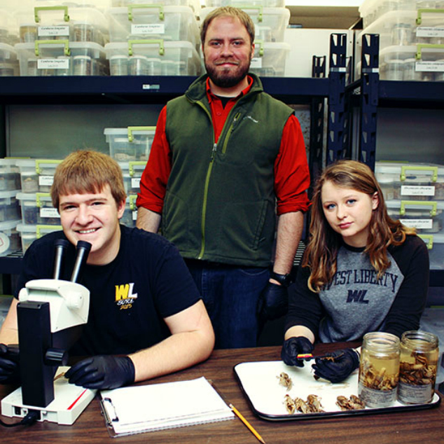 Dr. Zachary Loughman with students