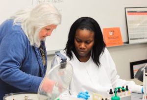 An MLS Program Student works with their instructor