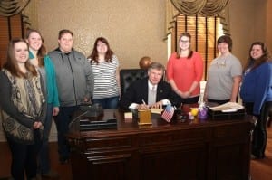 President Capehart signs the document proclaiming March Social Work Month at WLU. Members of the Social Work Club from left are: Alex Thistlethwaite, Julie Young, Clayton Craft, Arin Fields, Capehart, Melanie McFadden, Beth Trickett and Morgan Green.