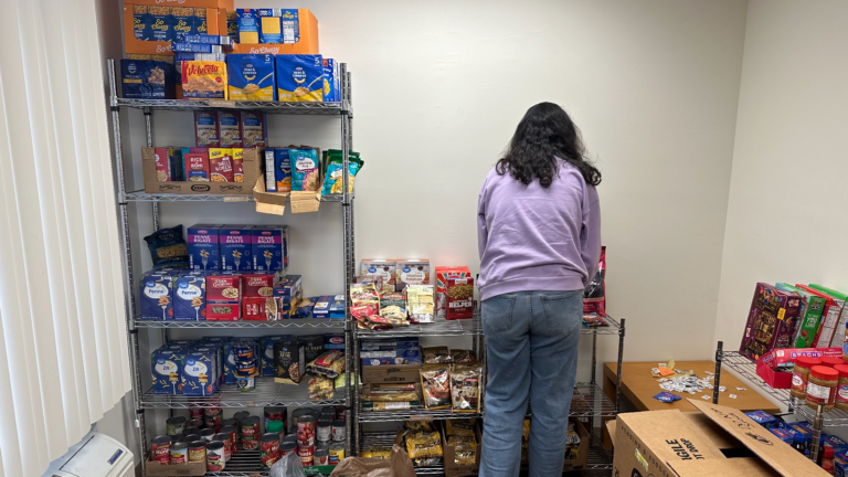 SGA Treasurer Ishika Agarwal stocking SOUP-er Bowl donations in WLU's Food Pantry