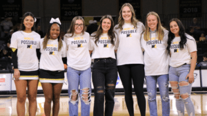 Students being recogmized at a basketball game