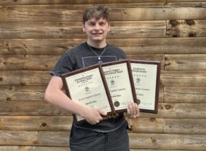 WLU student Chance Maffe with awards received at this summer’s national Phi Delta Theta conference.