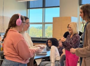 First-year MS SLP graduate students (left), Kendall Kropp and Maria Goudy are guided by second-year MS SLP graduate student (right), Kara Kapiskosky, and Dr. Carol Zombotti in preparing simulation experiences.