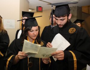 College of Arts and Communication graduates Kayla Stickley and Tony Viola study the program.