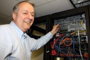 James Clark points to the new router as explains the significance of the technology.