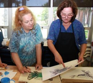 Art education graduate Rachel Shipley listens to Warhol artist Tresa Varner.