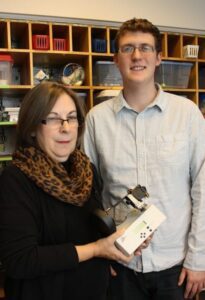 Director Lou Karas shows WLU senior Ryan Bland on of the robotic kits in the Center for Arts and Education.