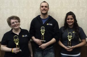 From left, Joelle Kidder, Philip Kruseman and Enza Tsouris display the WVAPA Academic Challenge Bowl 2014 winning trophies.