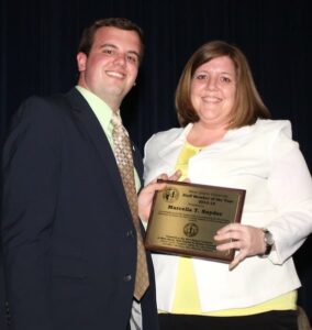 Marcella Snyder accepts her award from Student Government Officer Jeffrey Tice.