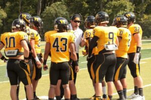Coach Ma'afala is shown center with members of the Hilltopper Football team.