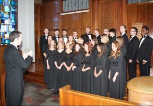 Dr. Scott Glysson conducts the choir in rehearsal.