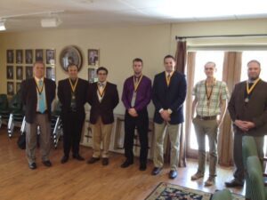 From left, Coach Jim Crutchfield, Joshua Taylor, Anthony Panebianco, Ben Rogers, C. J. Hester, Dan Lukich and Dr. Zac Loughman, gather after the Order of the Torch ceremony.
