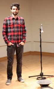 Adam Basanta stands near one of his installations