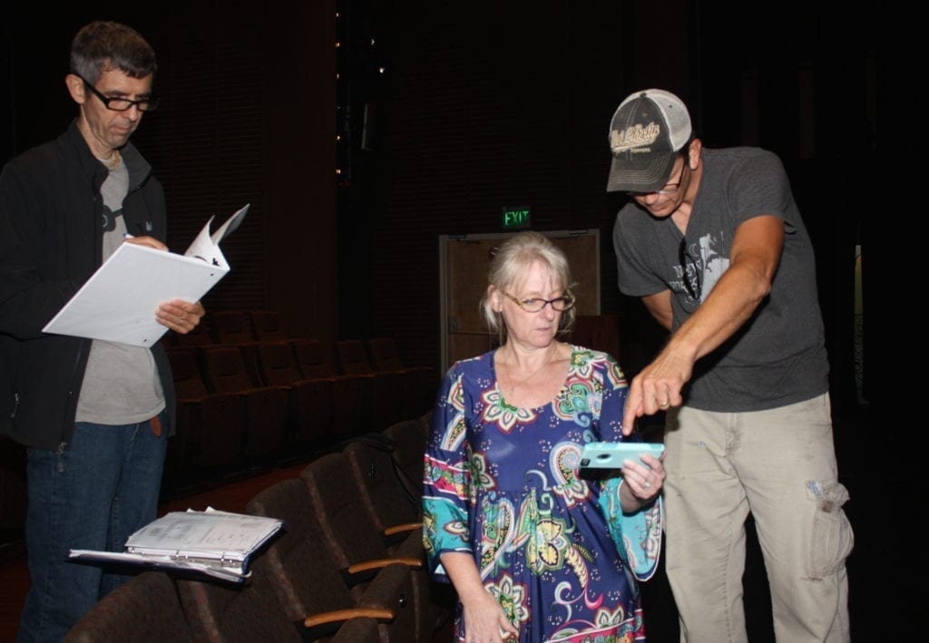 Playwright John Sherwood is shown at left, Melinda Kreisberg and Mike Aulick in the foreground.
