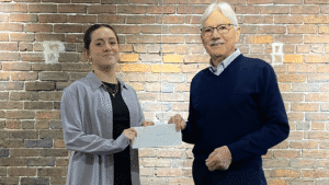 Dr. David Kepple granting Jaqueline Pena the prize money for web