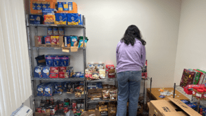 SGA Treasurer Ishika Agarwal stocking SOUP-er Bowl donations in WLU's Food Pantry