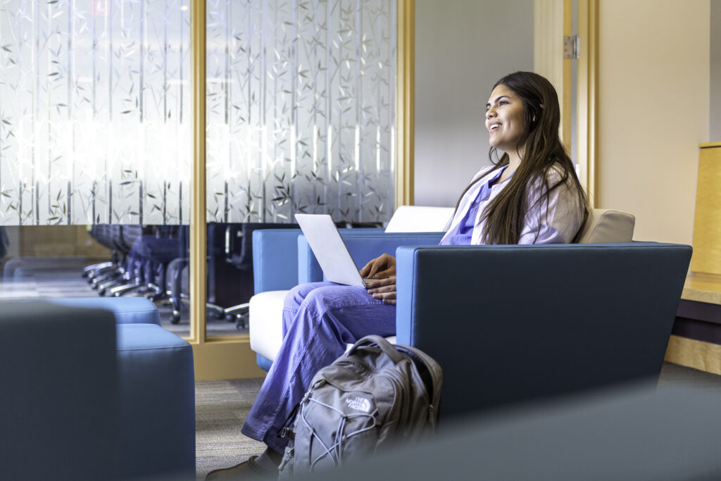 Student in Campbell Hall Blue Lounge scaled